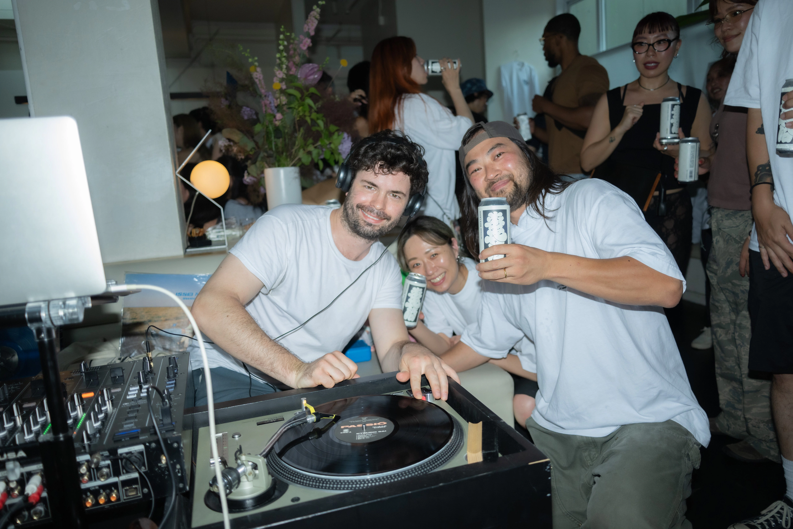 Guests posing together behind the DJ booth
