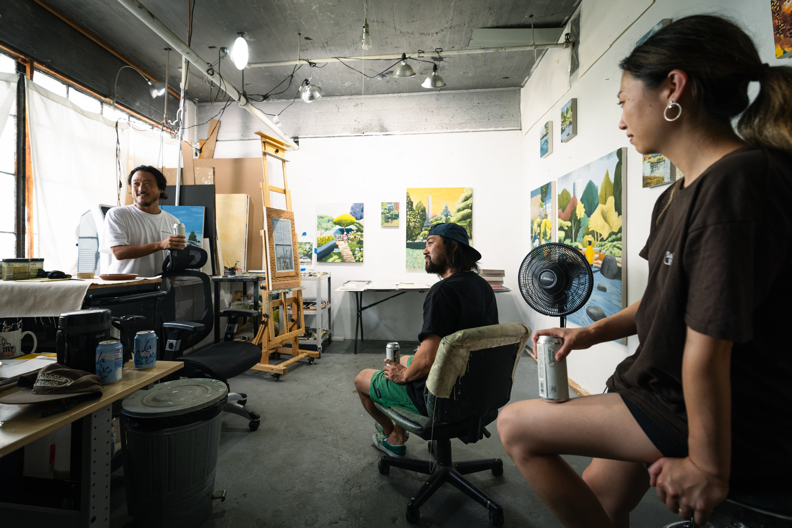 Artists and guests gathered in a working studio