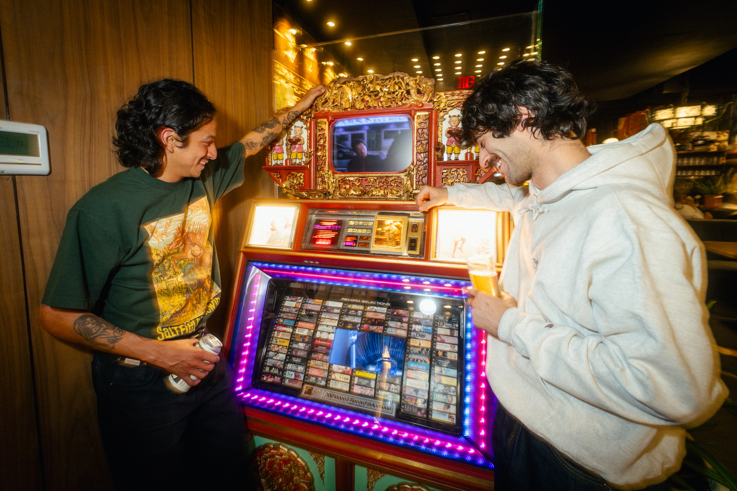 Two guests playing an arcade game