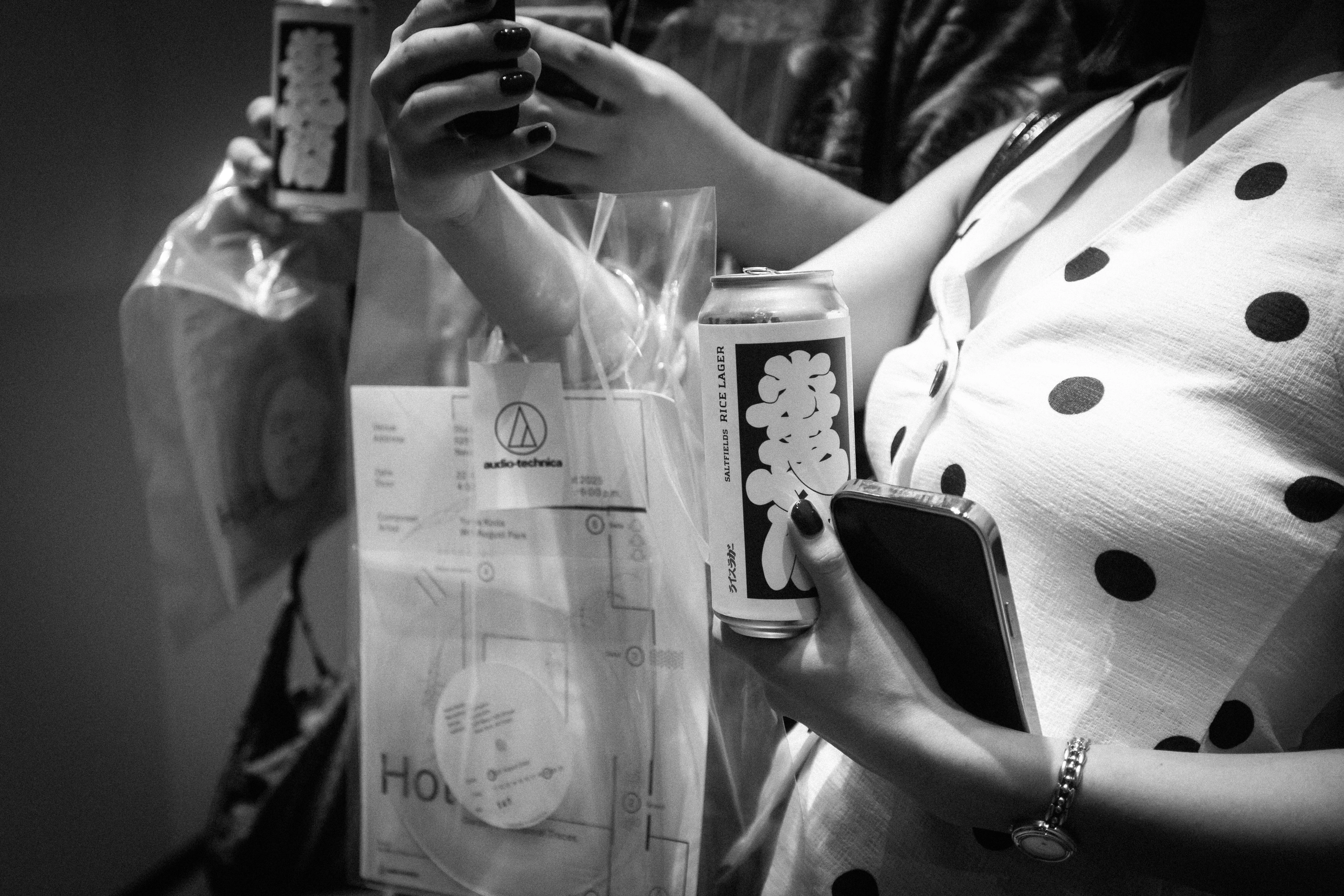 A guest holding a Saltfields can and event bag