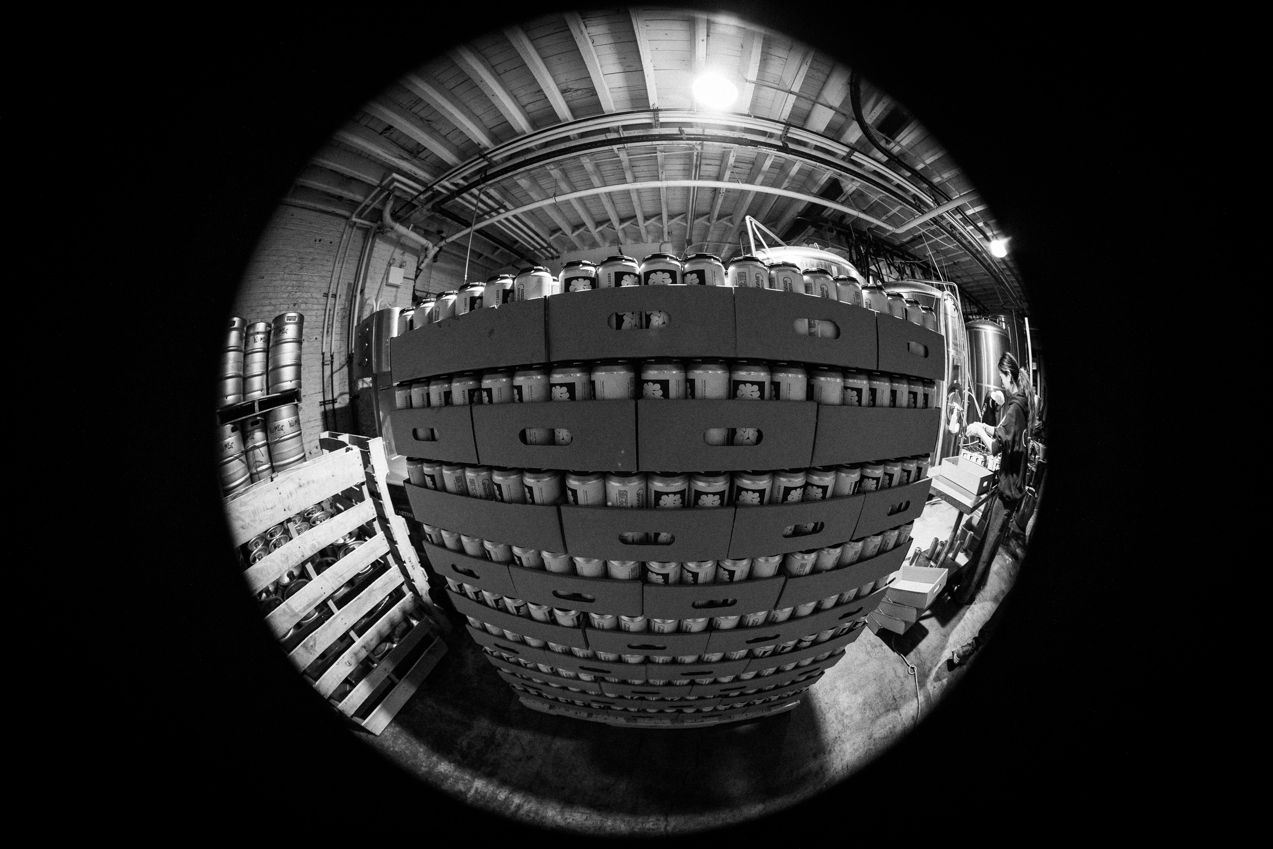A fisheye view of stacked cans on the production line